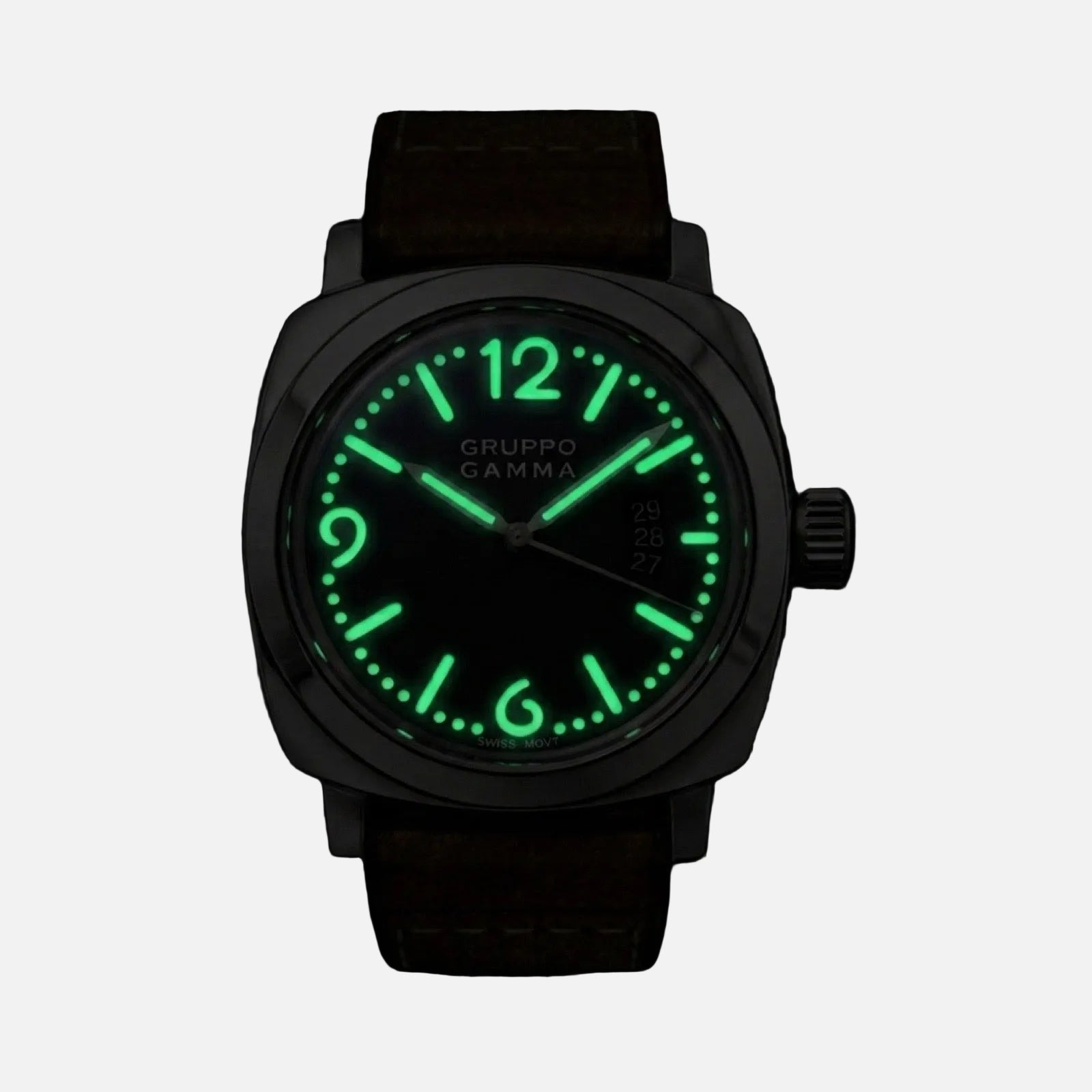 A Gruppo Gamma wristwatch with a dark gunmetal case, brown leather strap, and a glowing green luminescent dial and hour markers, shown against a solid black background.